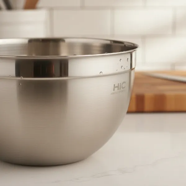 A close-up shot of the HIC Harold Import Co. Stainless Steel Mixing Bowl, highlighting its brushed finish and reinforced rim on a kitchen counter.