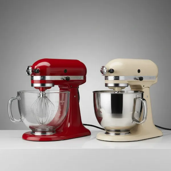 A side-by-side comparison of a KitchenAid stand mixer with a glass bowl and another with a stainless steel bowl