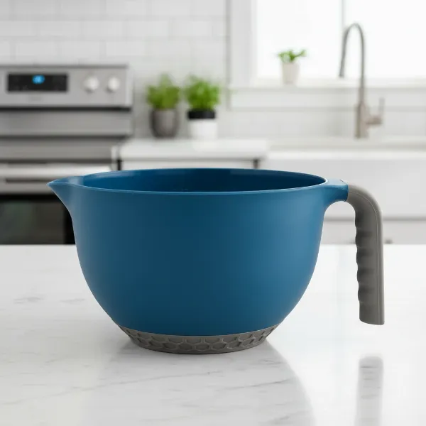 A close-up of a high-quality plastic mixing bowl highlighting features like a non-slip base, pour spout, and ergonomic handle.